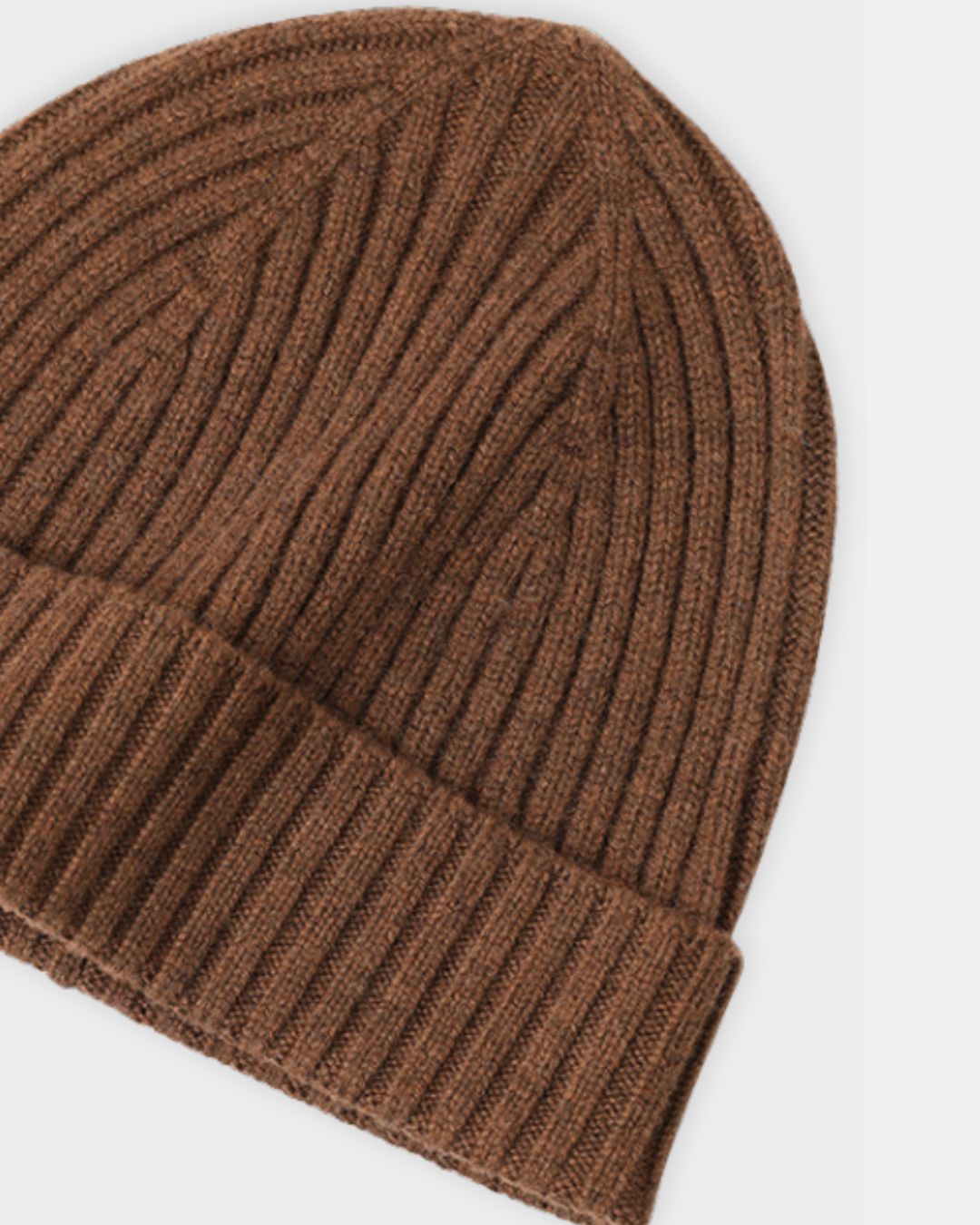 Brown ribbed cashmere beanie with a folded cuff, showcasing a soft knit texture for winter.