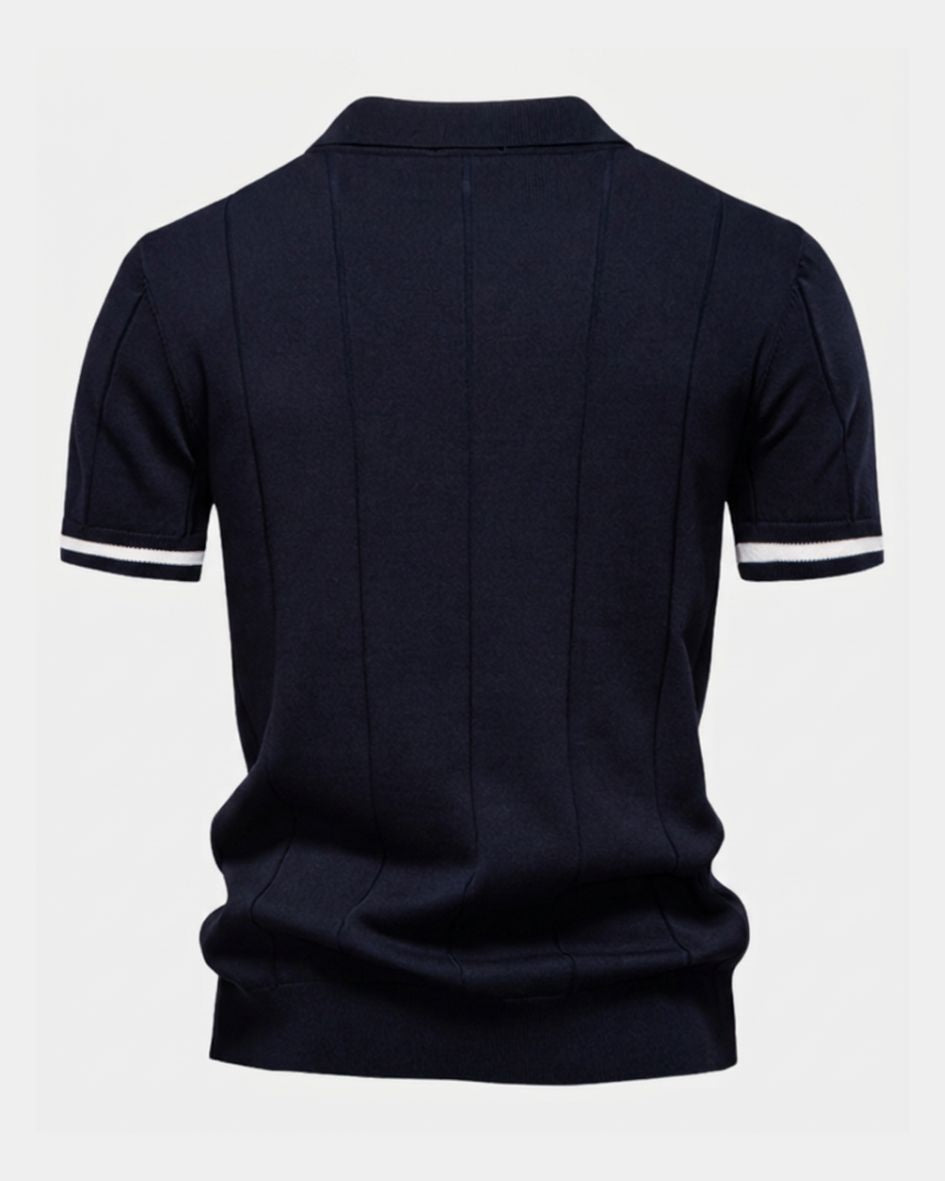 Black polo shirt with white trim on sleeves and collar against a light gray background