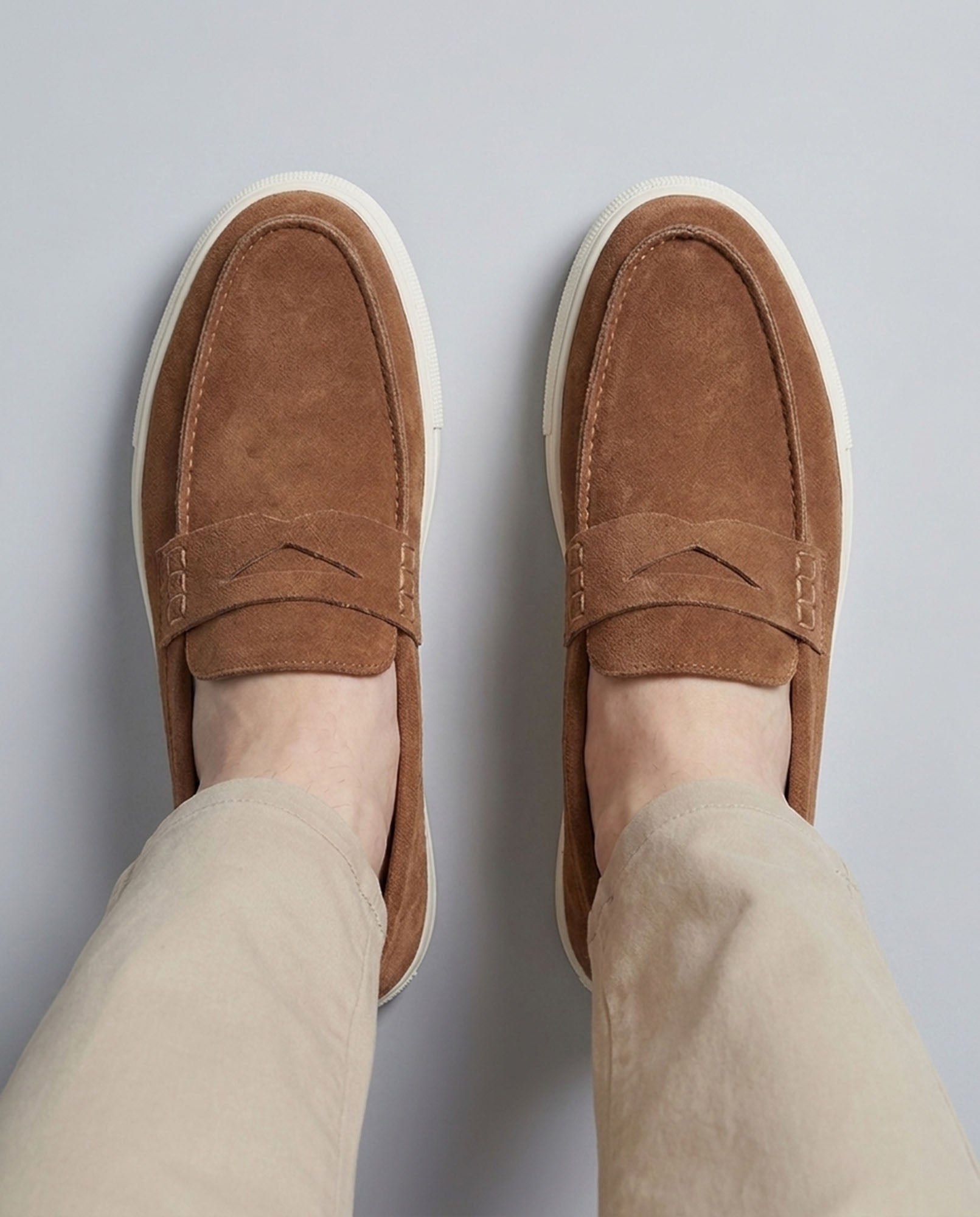 
Overhead view of Dunley men's camel penny loafers with off-white cupsole