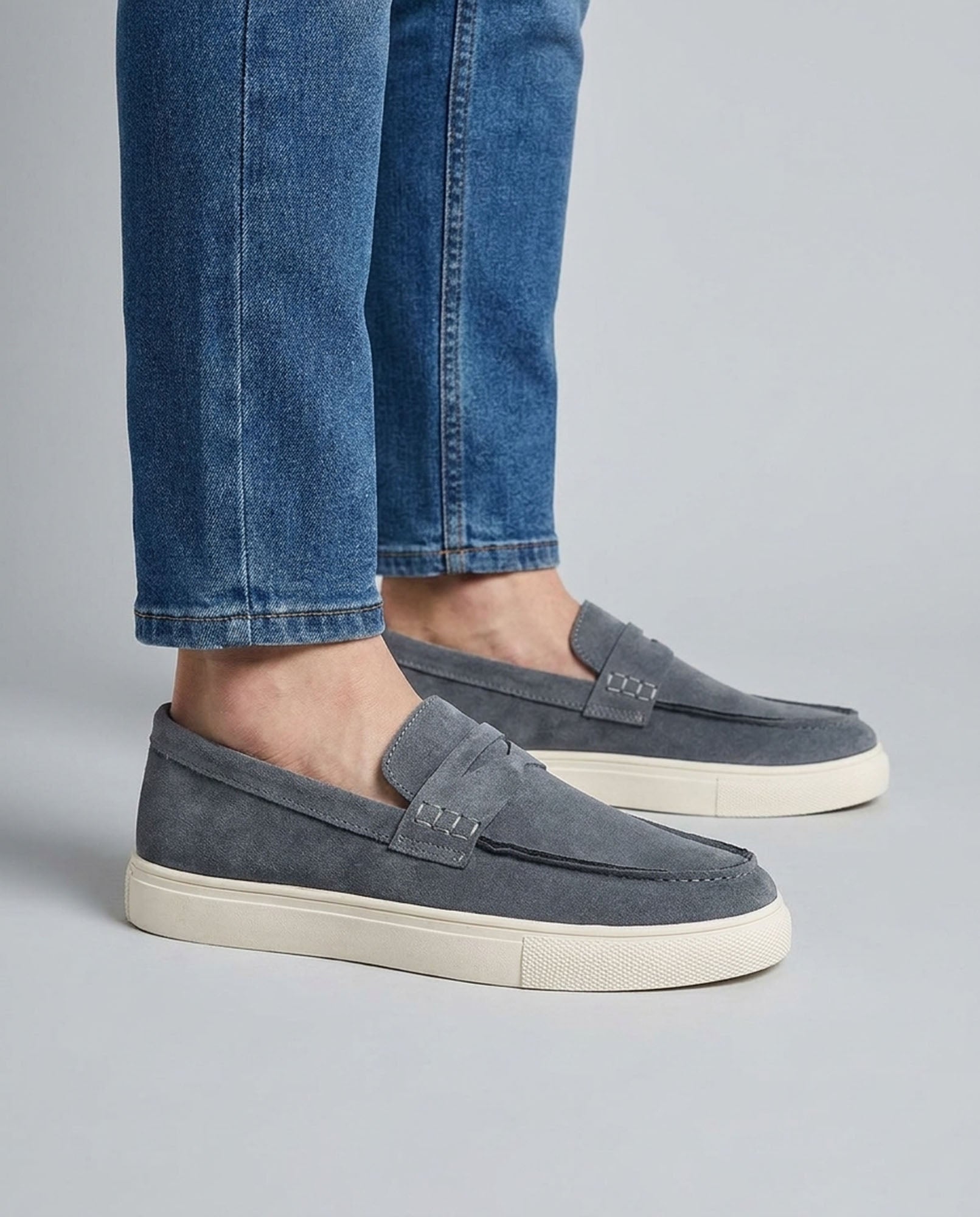 Dunley men's steel blue penny loafers worn with blue jeans