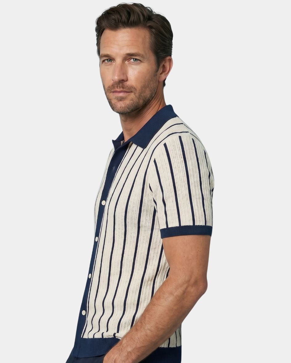 Man wearing a striped shirt with navy and white colors on a plain background