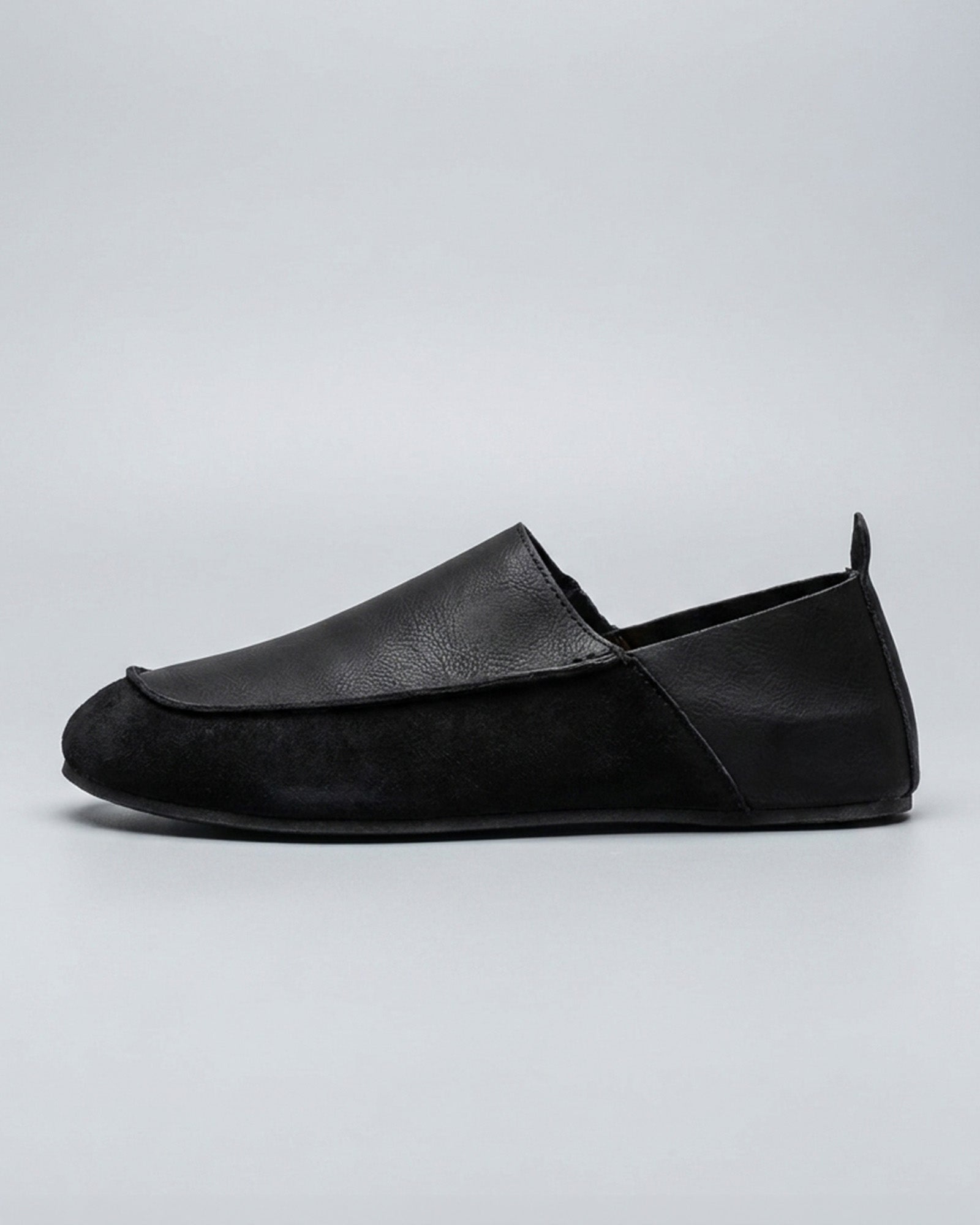 Side view of Luca men's black relaxed slip-on loafer with contrast vamp panel