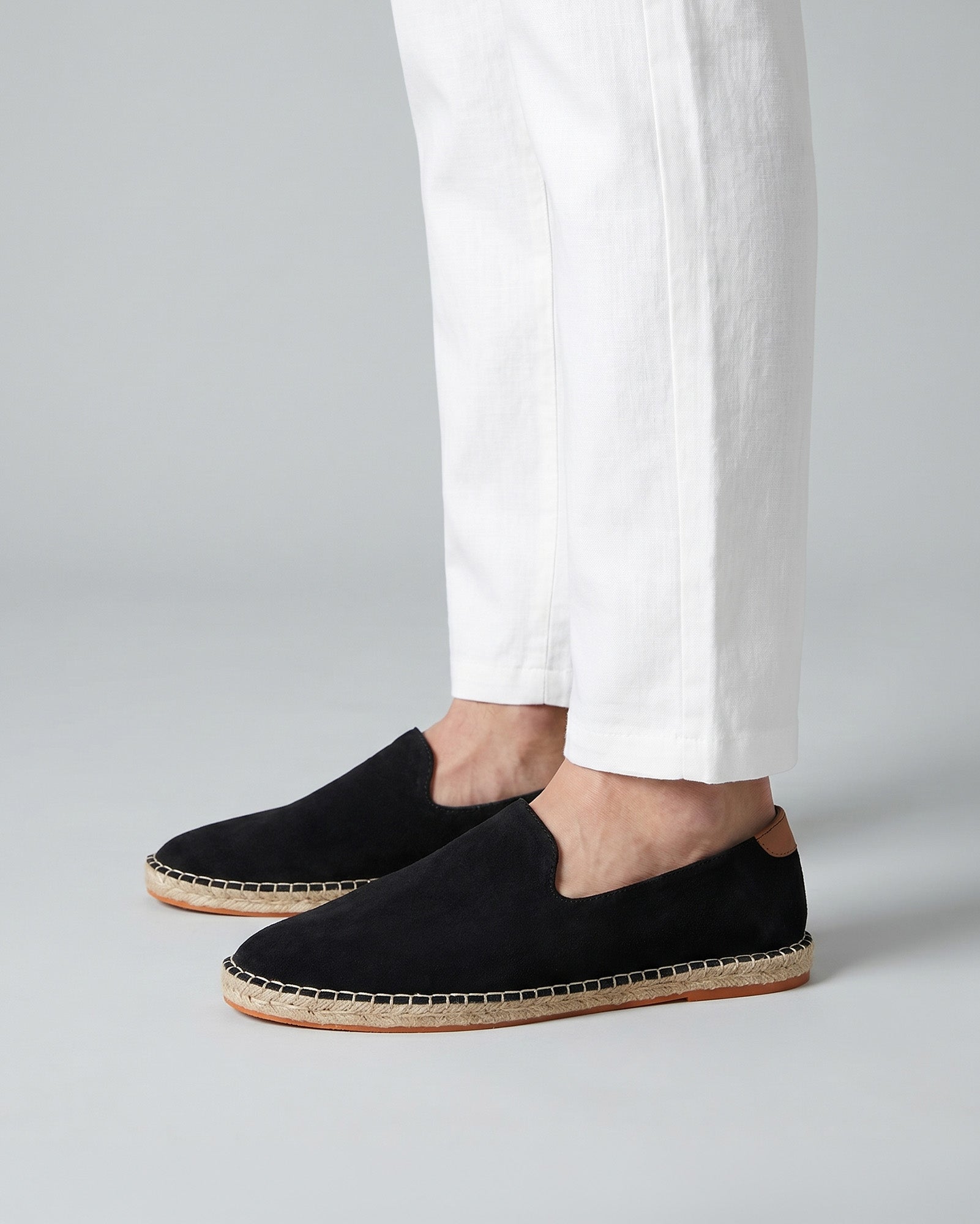 Malaga men's black suede espadrille loafers worn with white linen trousers
