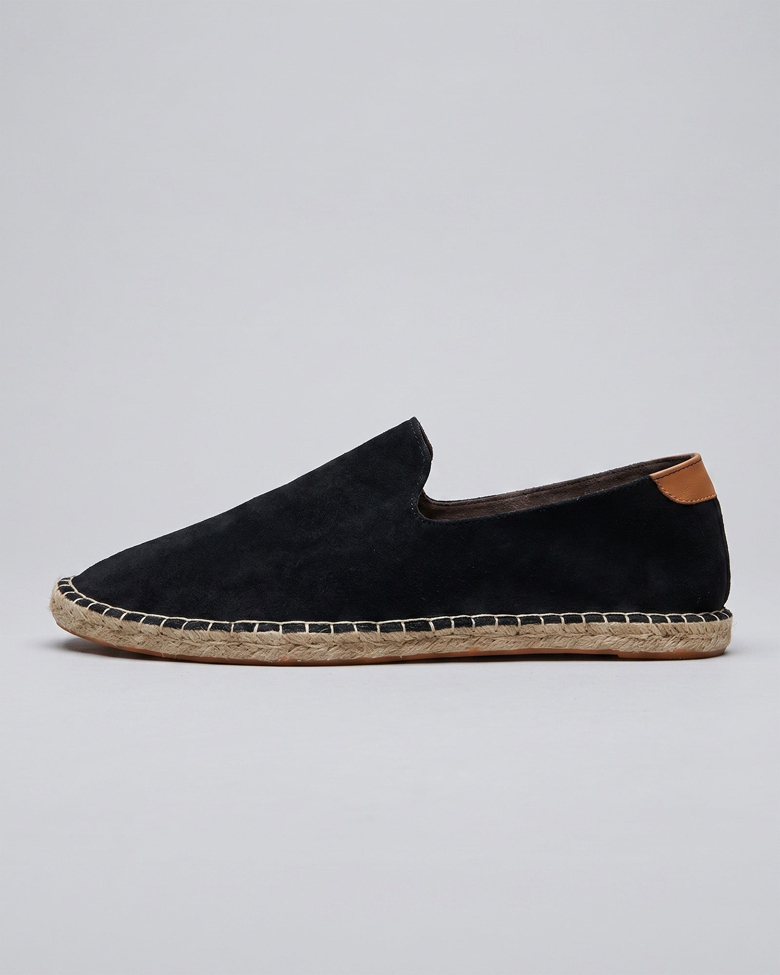 Side view of Malaga men's black suede espadrille loafers with tan heel counter and jute rope sole