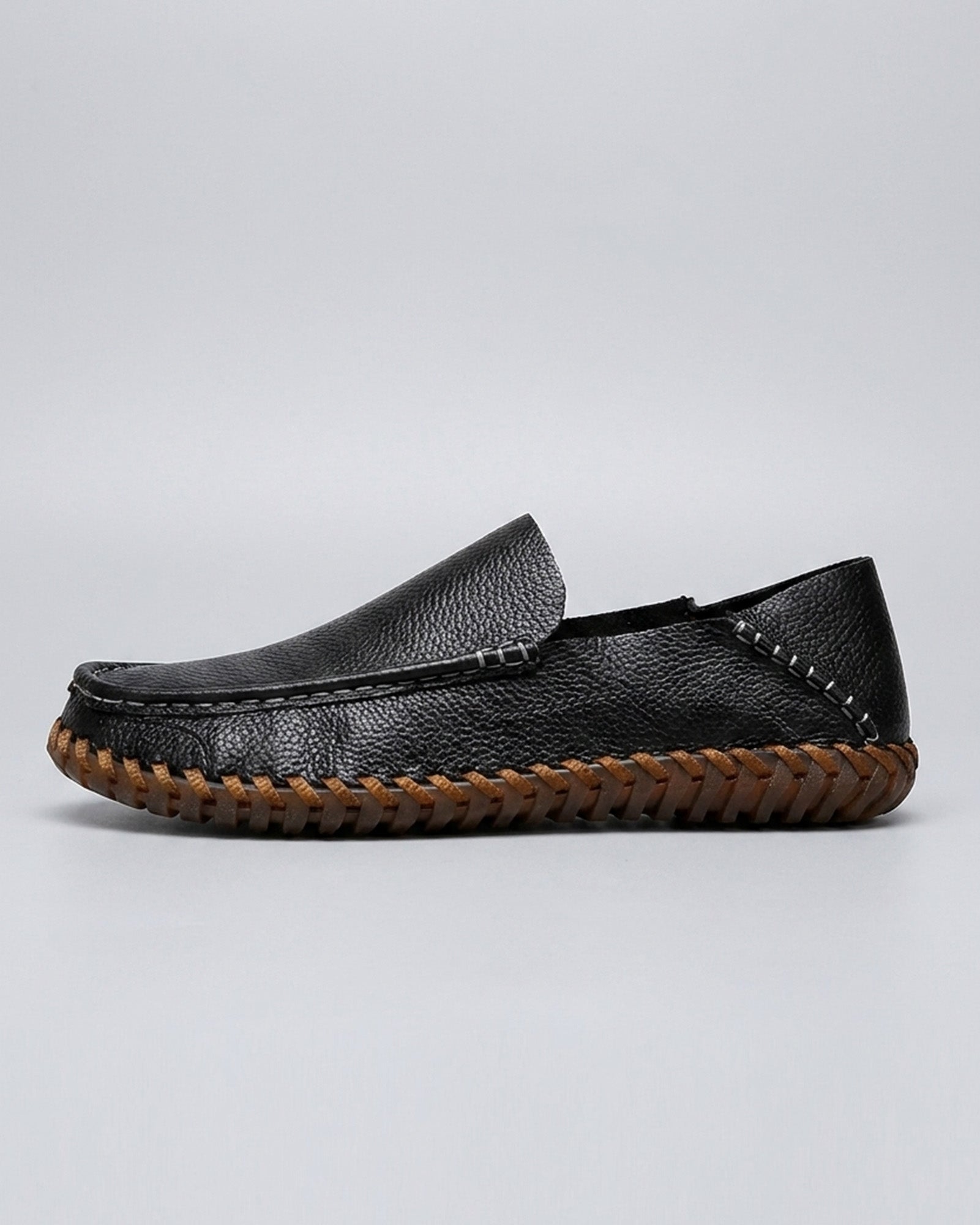 Side view of Marlow men's black leather driving loafer with woven sole detailing