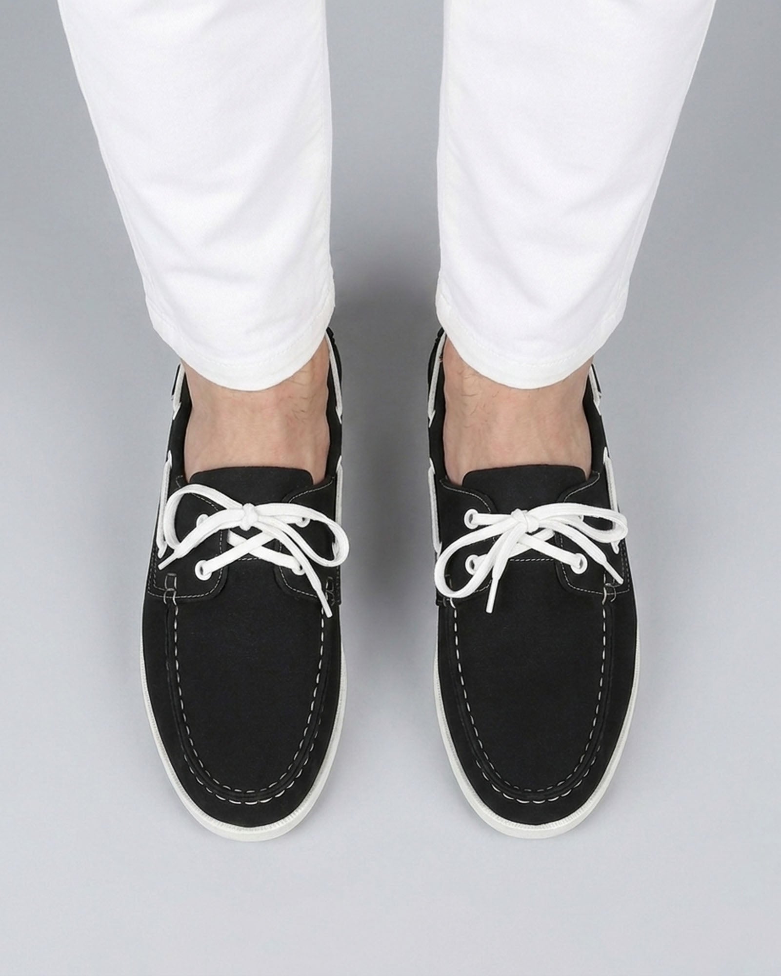 Nightdock men's black boat shoes styled with white trousers - overhead view