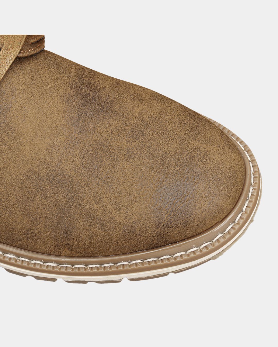 Close-up of a brown men's casual ankle boot featuring a round toe, textured finish, and a contrast rubber sole with stitching.