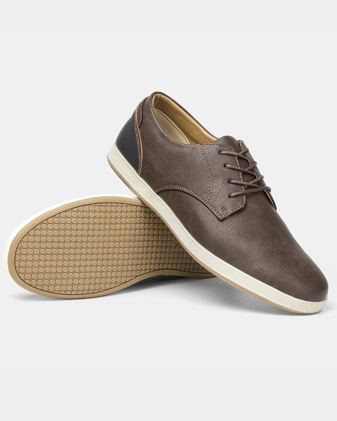 Brown synthetic leather men's lace-up dress sneakers with a white rubber sole and textured traction base.