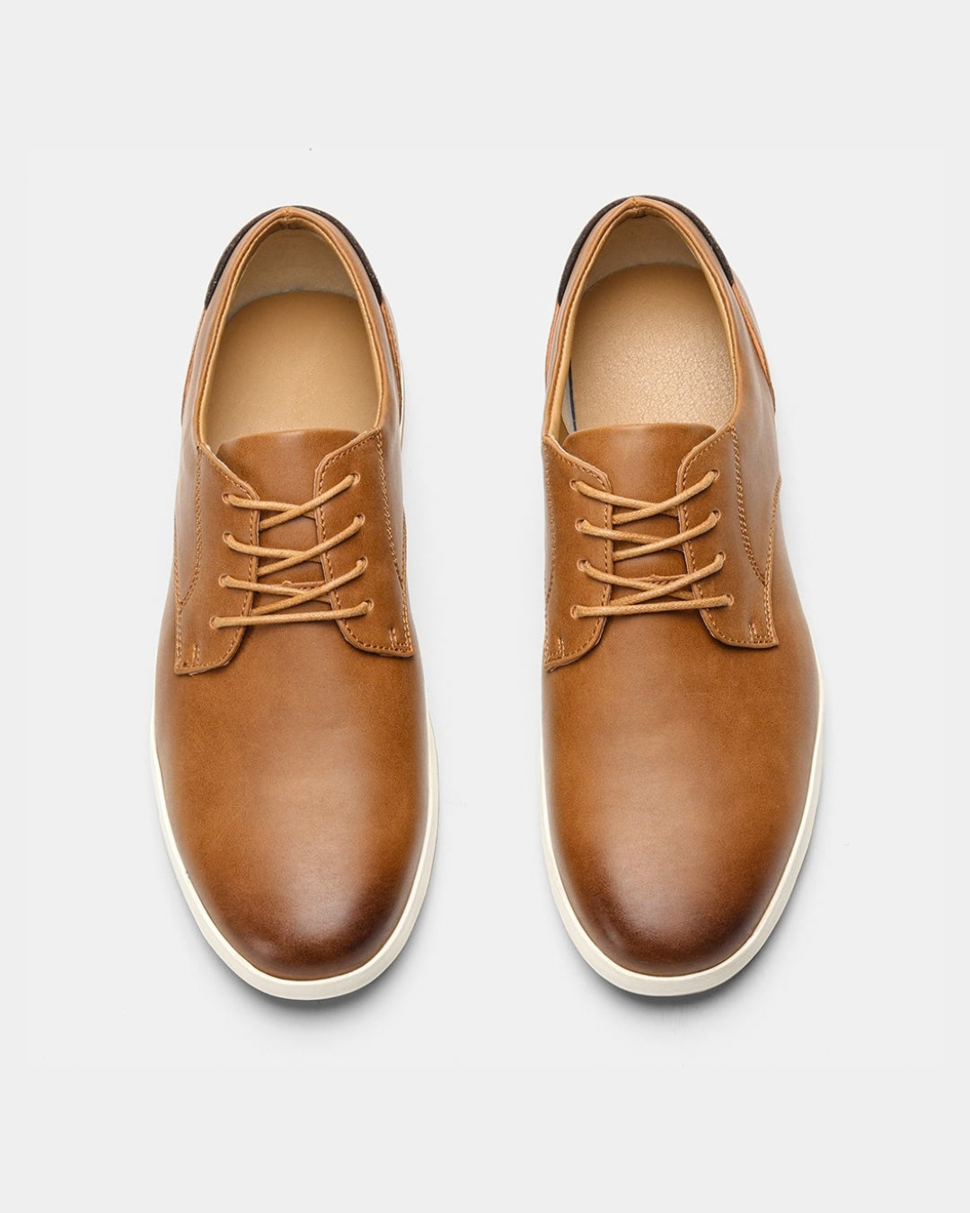 Tan synthetic leather lace-up dress sneakers with a clean derby design and a white rubber outsole.