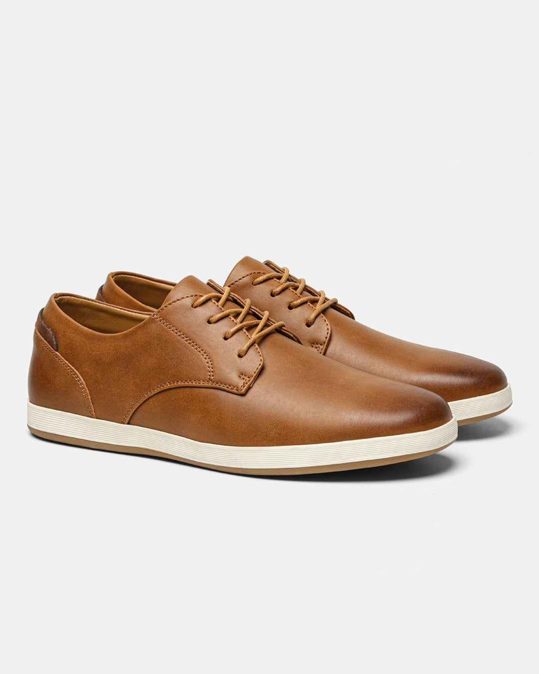 Tan synthetic leather men's casual dress sneakers with a classic lace-up design and a white rubber outsole.