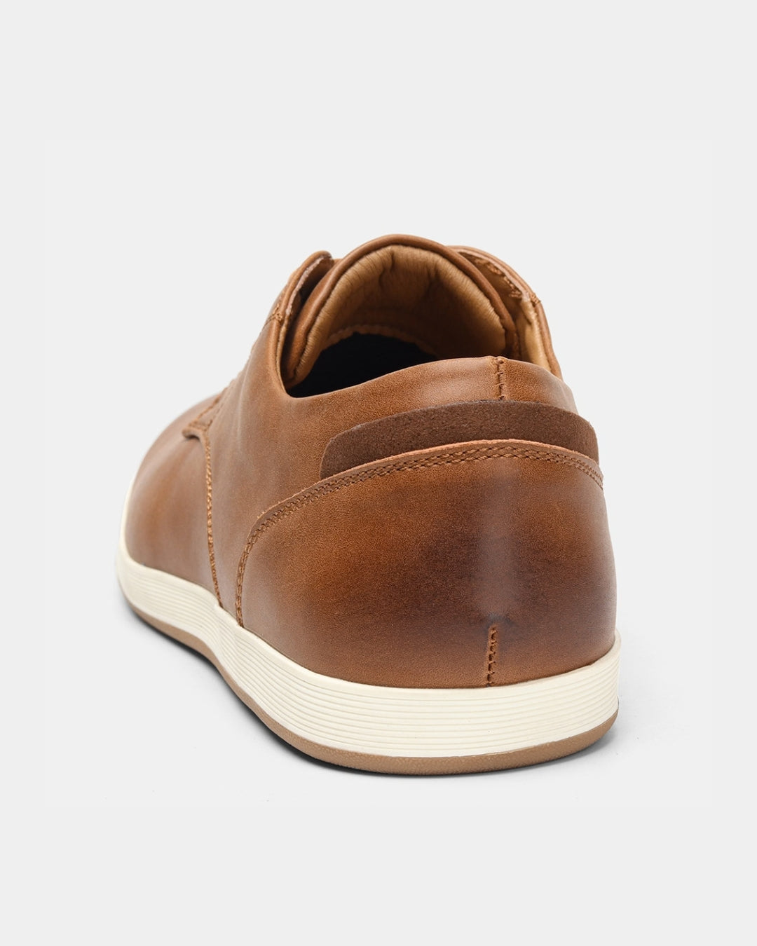 Tan synthetic leather men's casual dress sneaker with a white rubber sole and cushioned heel detail.