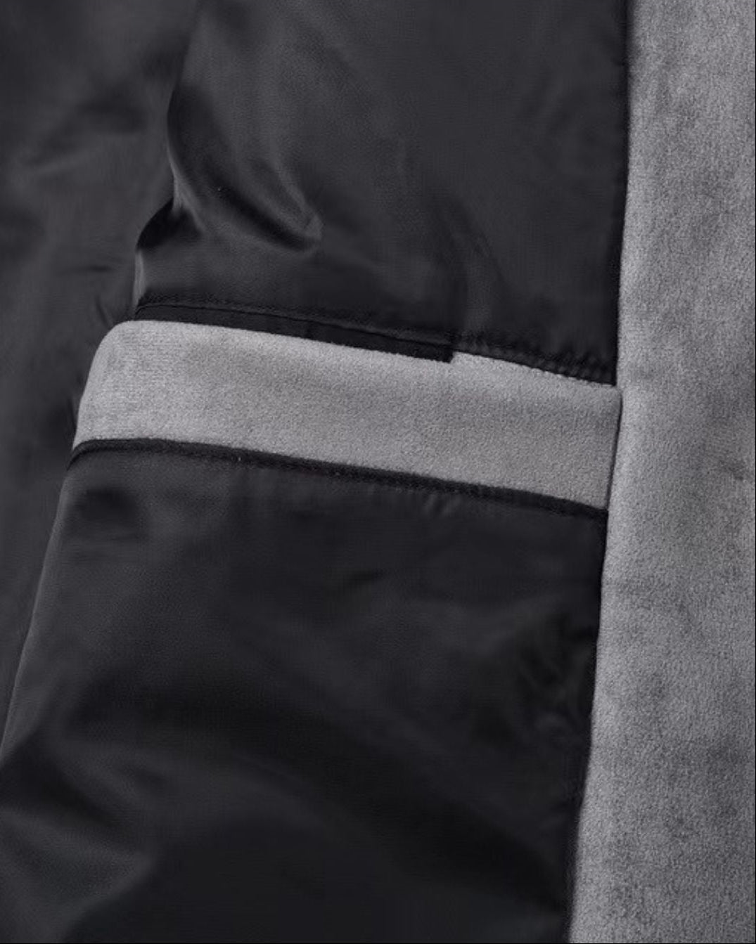 Close-up detail of a men's gray casual zip-up suede look overshirt jacket showing the inner pocket