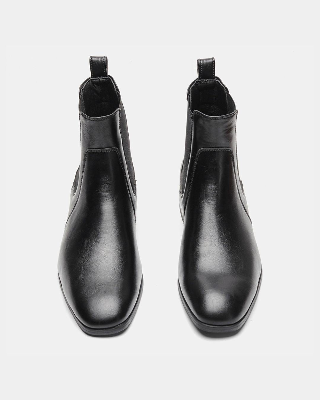 Men’s black Chelsea dress boots with a smooth finish, square-toe silhouette, and elastic side panels on a white background.