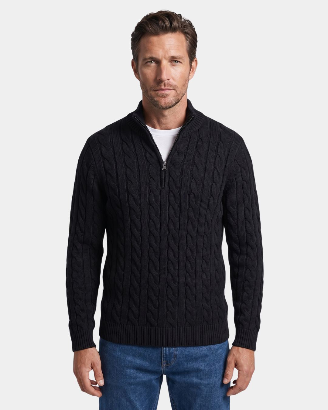 Man wearing a black cotton cable knit quarter-zip sweater with a mock-neck collar, ribbed cuffs, and hem.
