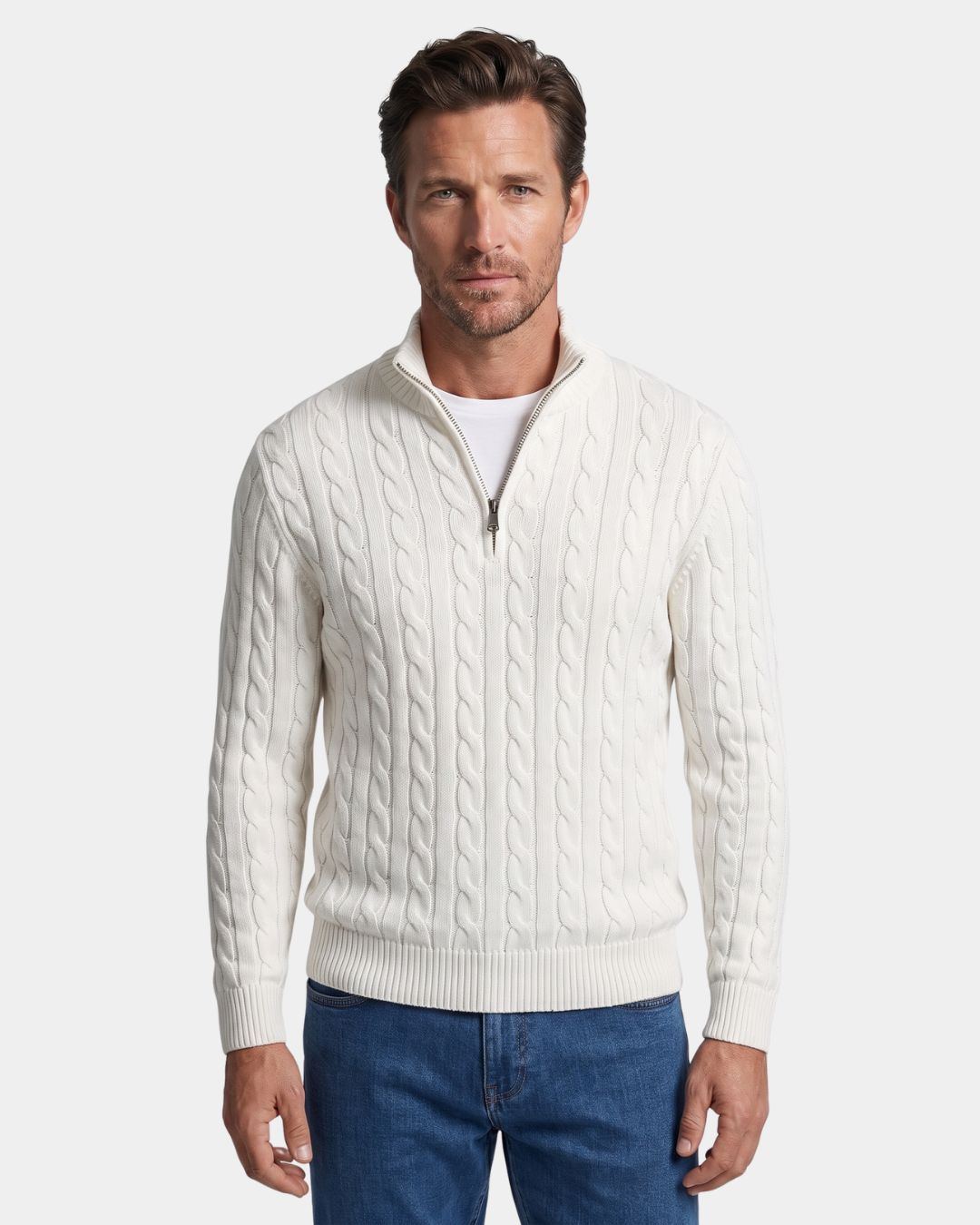 Man wearing a white 100% cotton cable knit quarter-zip sweater with a mock-neck collar and ribbed cuffs.