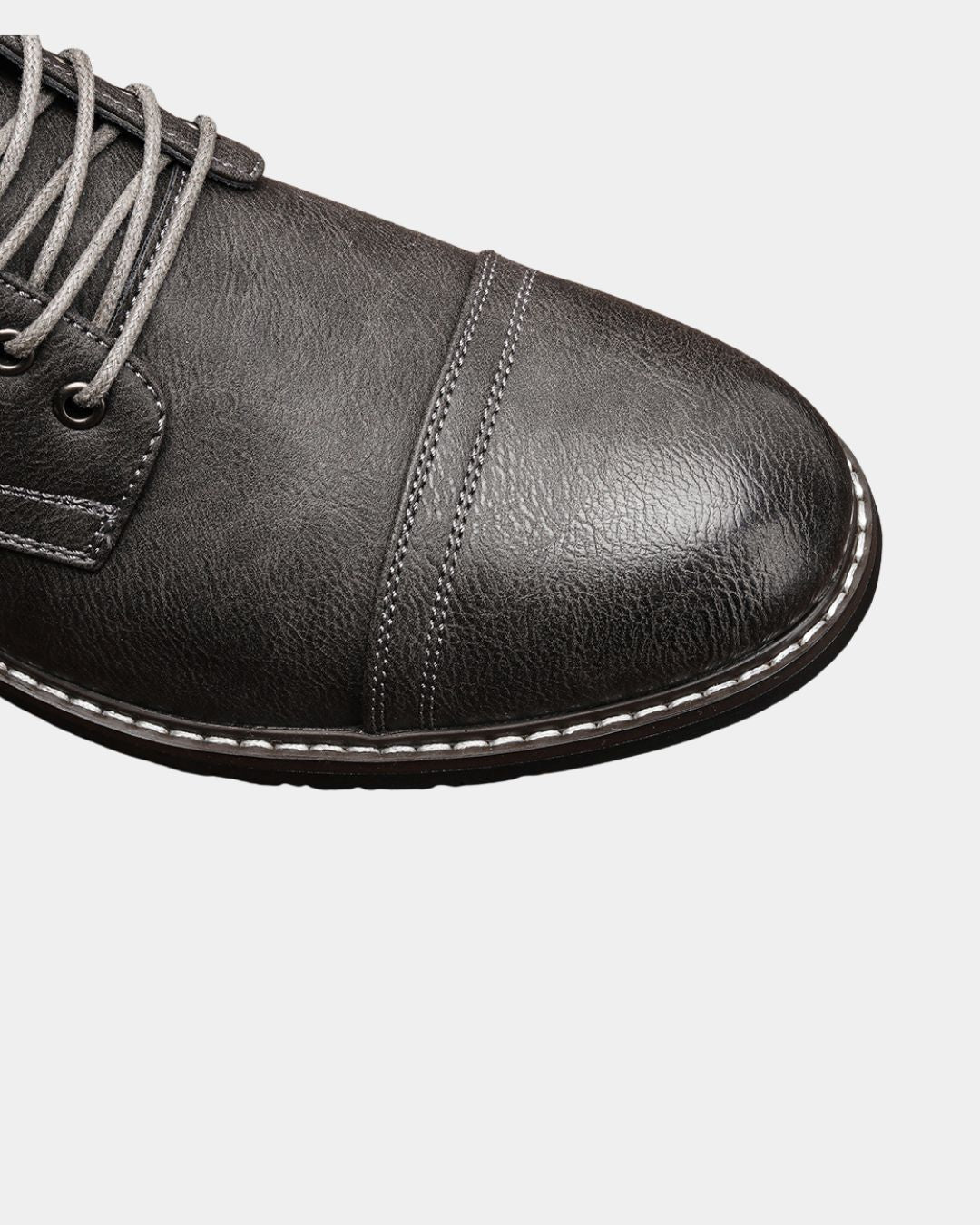 Dark brown textured cap-toe ankle boot with contrast stitching, metal eyelets, and grey laces.