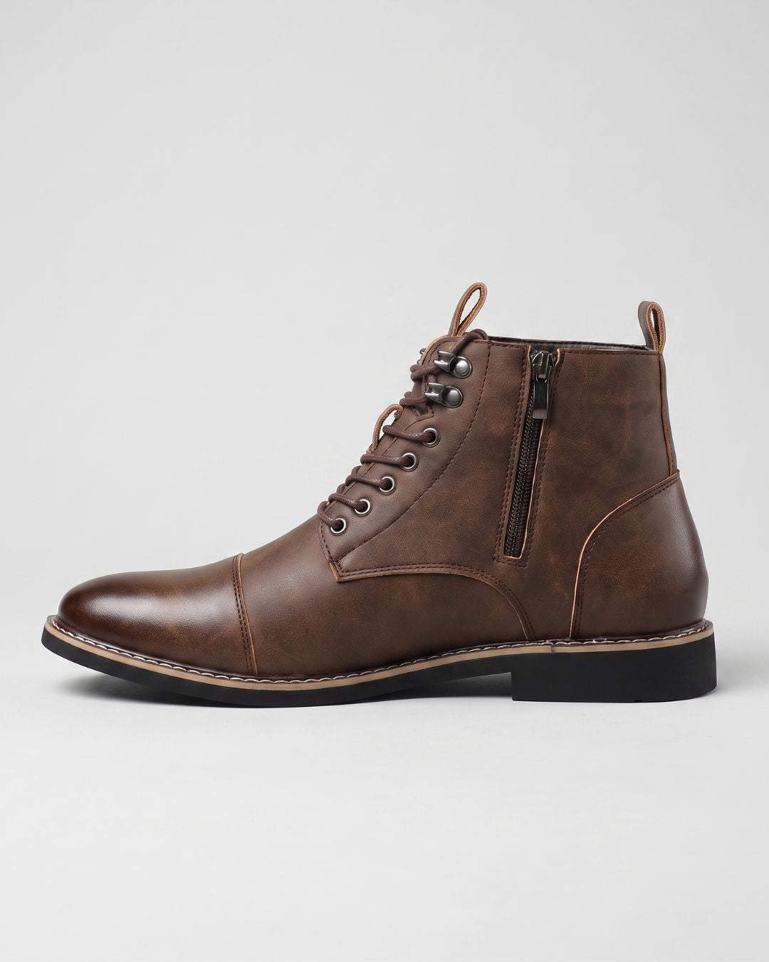 Brown leather cap-toe ankle boots with side zipper, lace-up front, metal eyelets, and a durable rubber outsole.