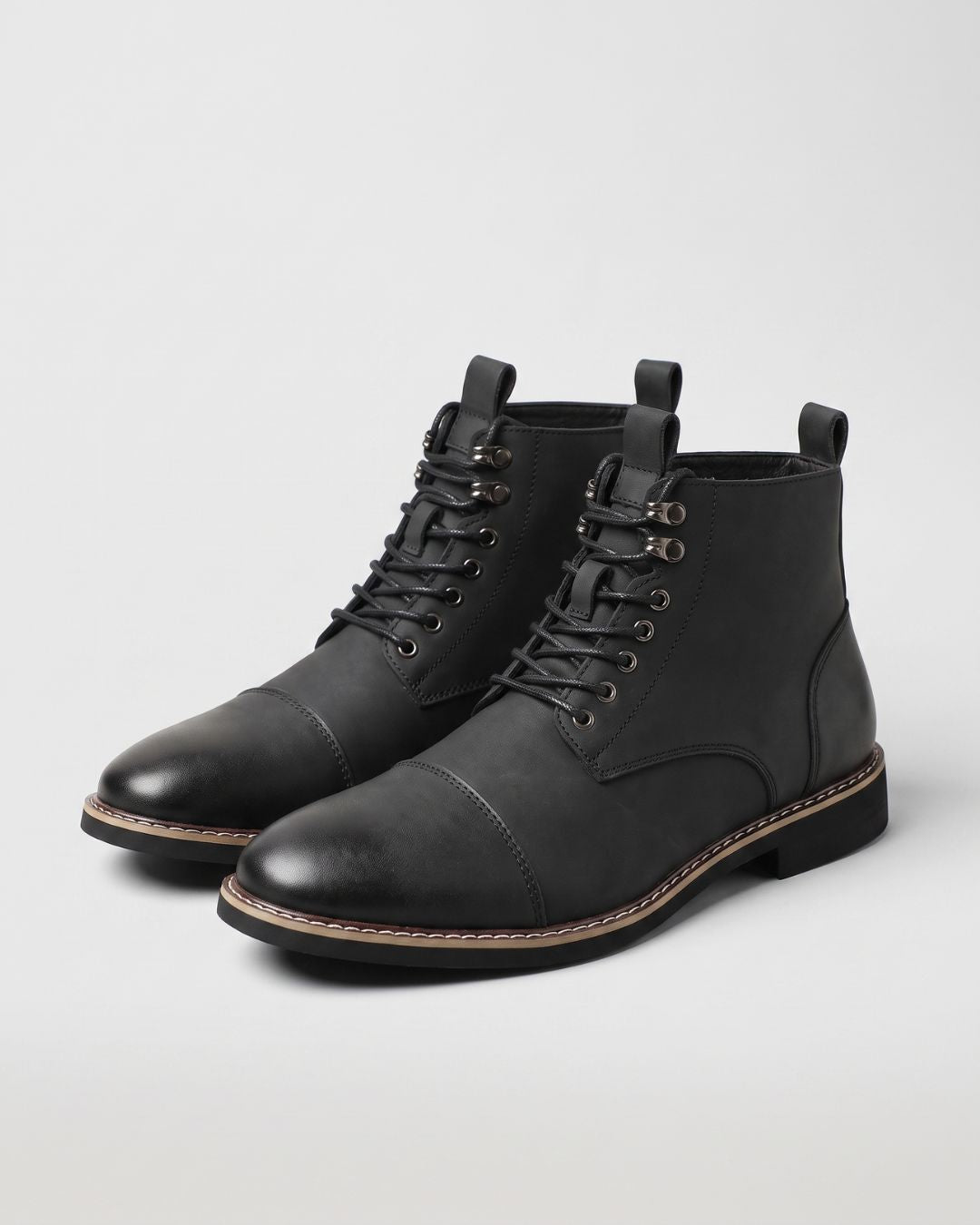 Men’s black cap-toe ankle boots with lace-up front, metal eyelets, and a convenient side zipper on a white background.