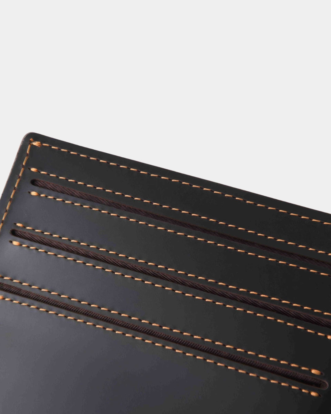 Dark brown Crazy Horse leather bifold wallet featuring three card slots and detailed contrast stitching.