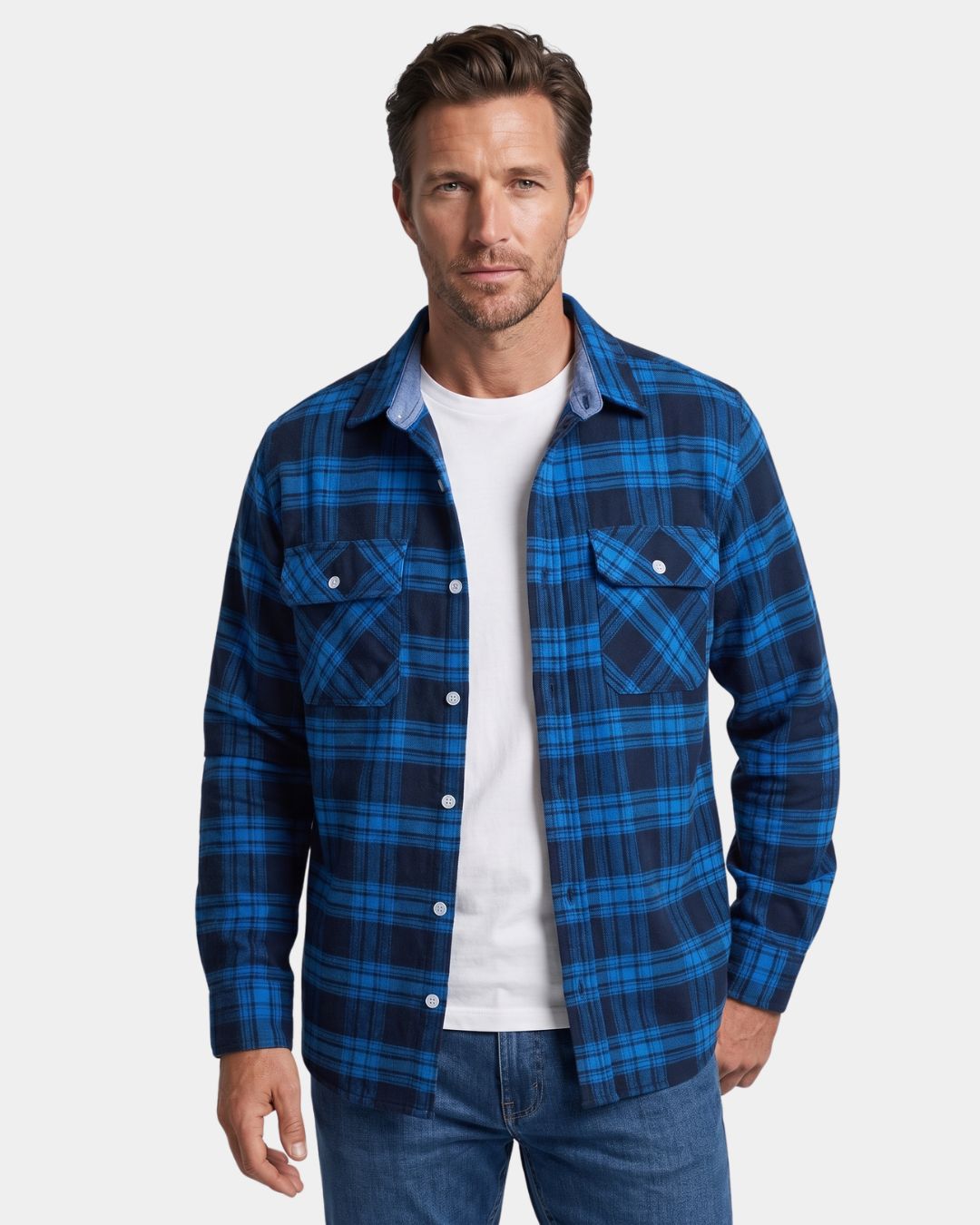 Man wearing a blue and navy plaid brushed flannel shirt with two chest pockets and a button-front design.