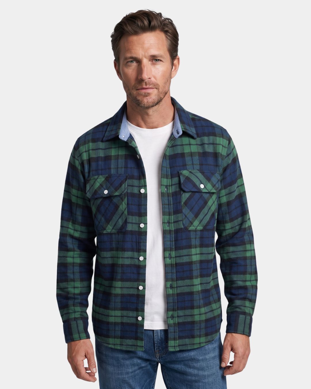 Men’s green and navy plaid flannel shirt with a button-front, two chest pockets, and a relaxed fit over a white T-shirt.