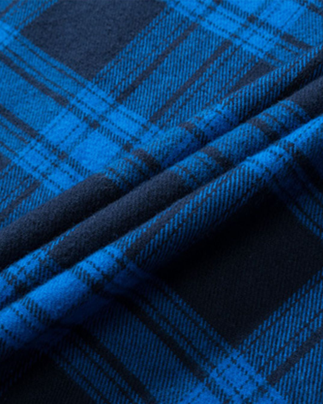 Soft, brushed blue and navy plaid flannel fabric with a textured, folded finish.