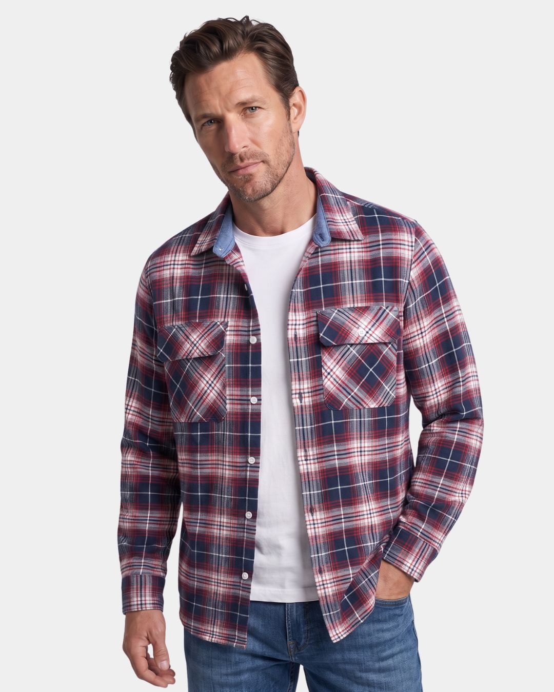 Man wearing a red and navy plaid brushed flannel shirt with two chest pockets over a white t-shirt.