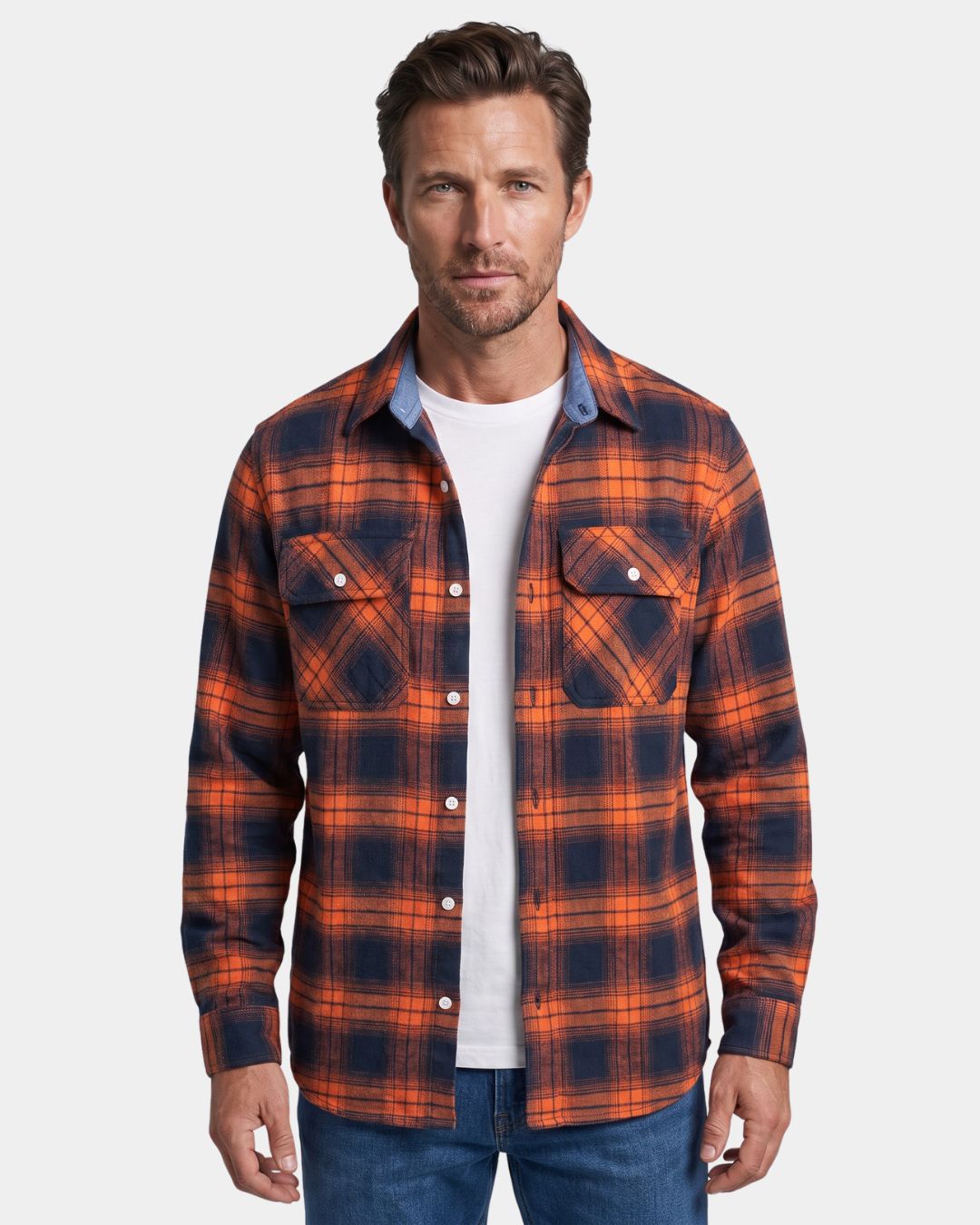 Man wearing a soft, brushed orange and navy plaid flannel shirt with two chest pockets and a button-front design.