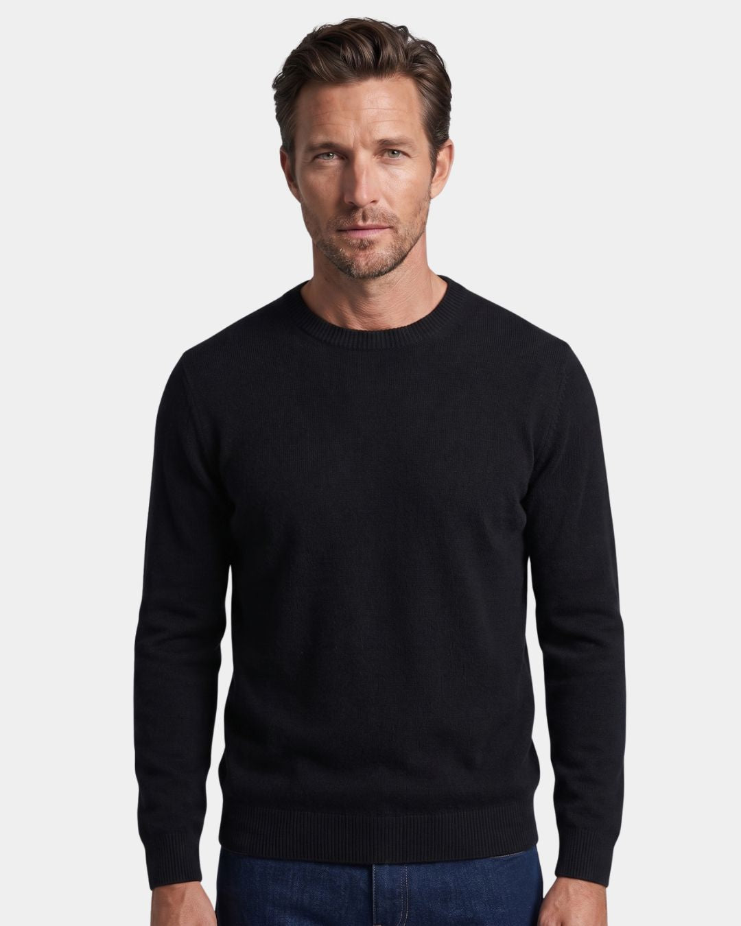Man wearing a black 100% wool crew neck sweater with ribbed cuffs and hem against a white background.