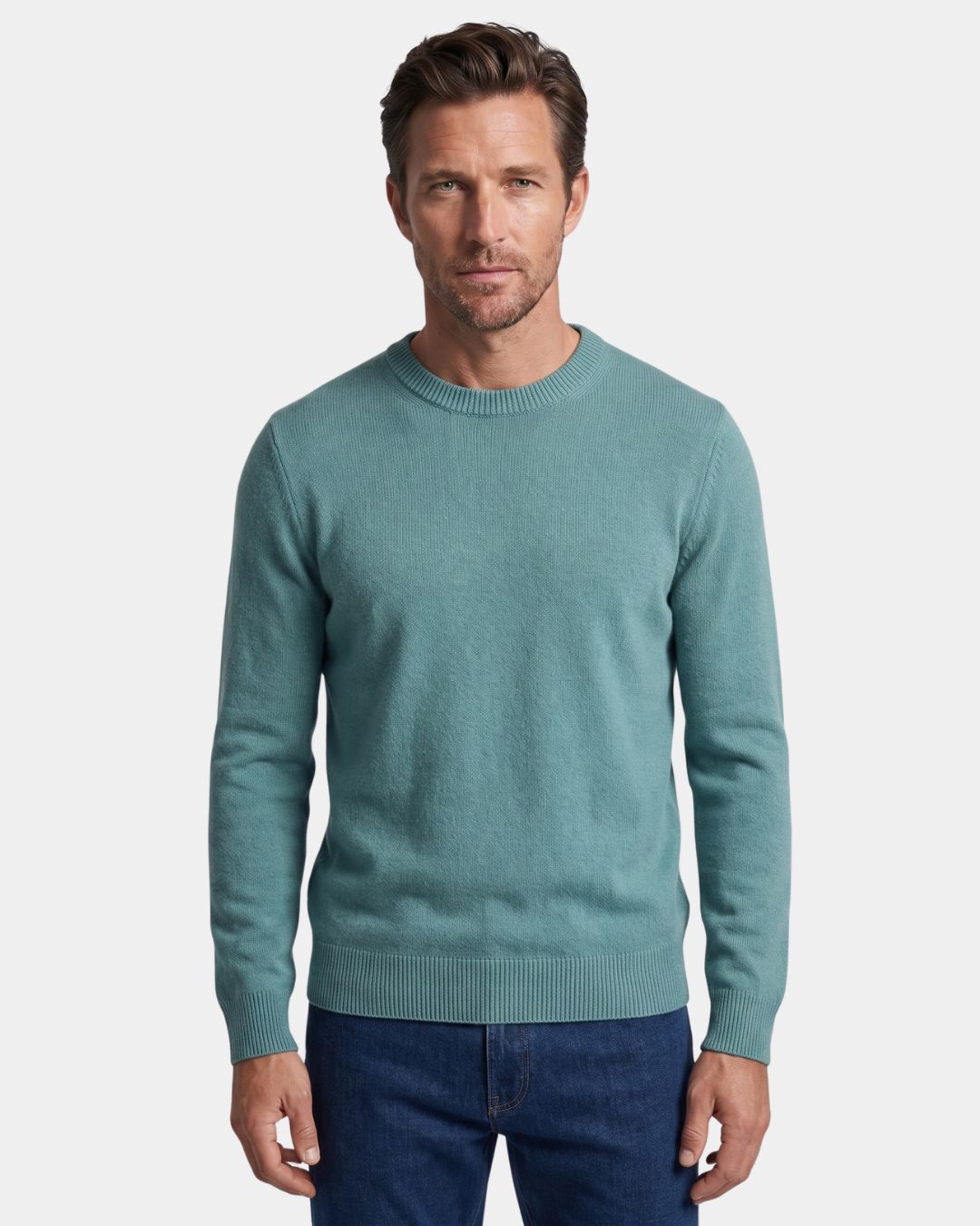 Man wearing a teal 100% wool crew neck sweater with ribbed trim and a clean, regular fit.
