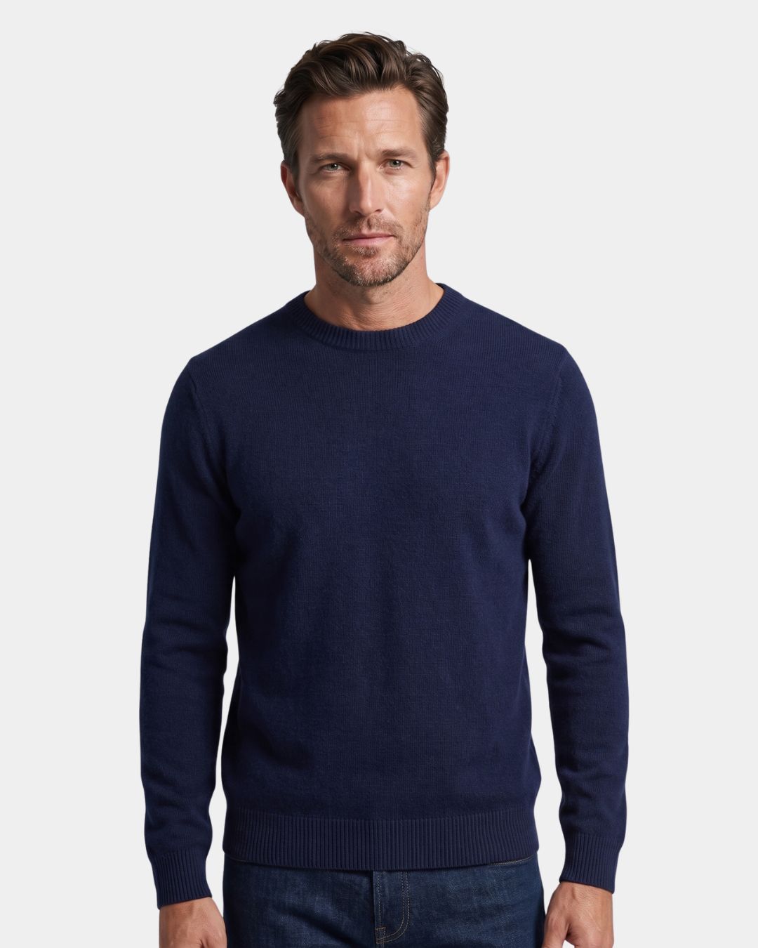 Man wearing a navy blue 100% wool crew neck sweater with ribbed trim and a clean, regular fit.