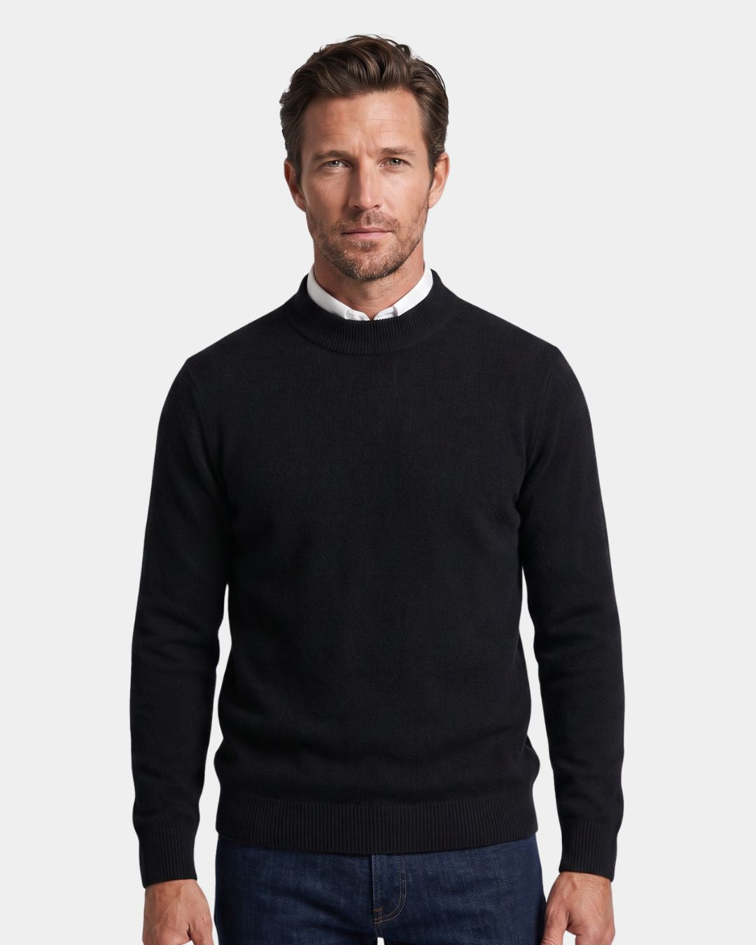 Man wearing a black 100% wool mock neck sweater with a white collared shirt underneath.