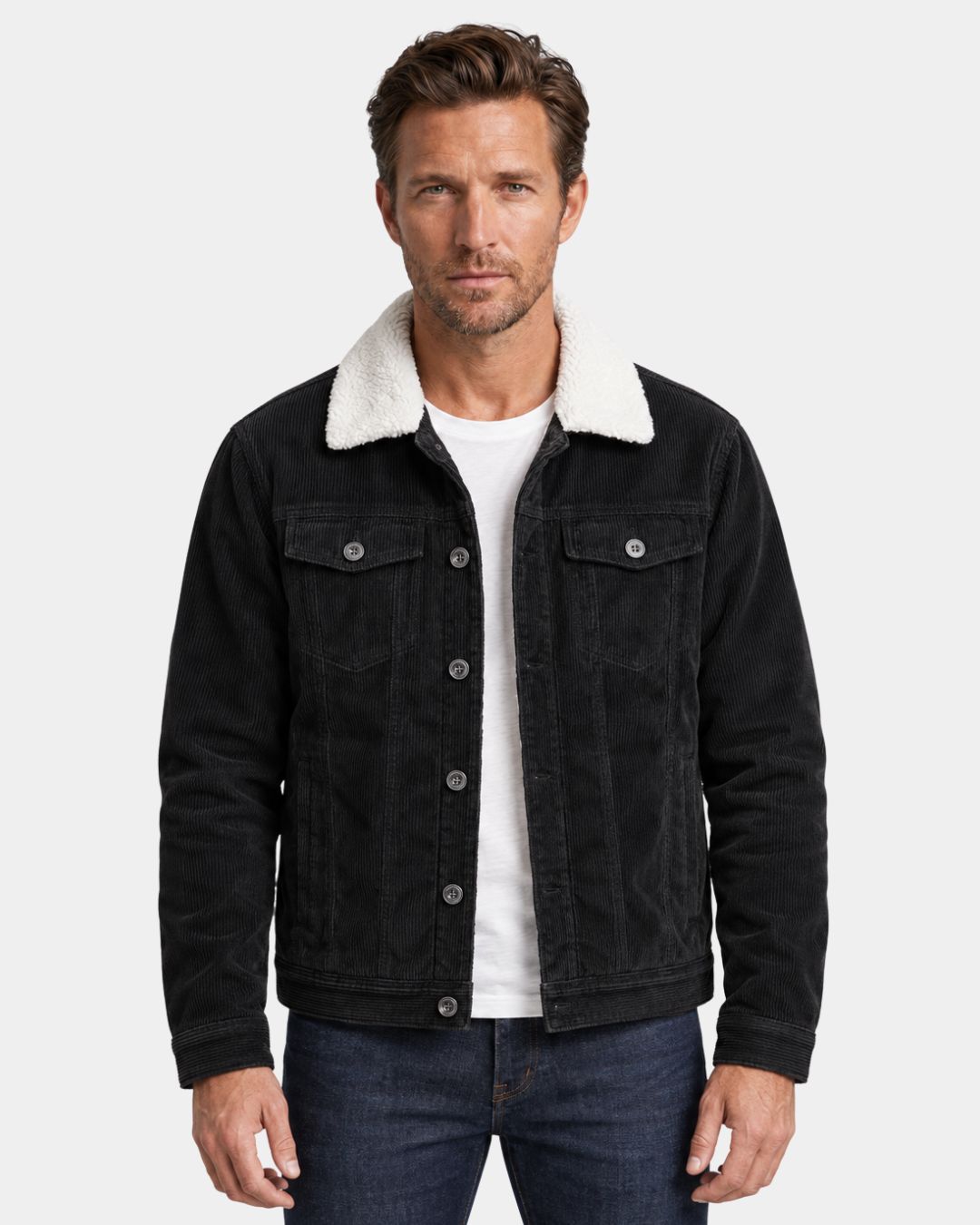 Black corduroy trucker jacket with a white sherpa collar, button-front closure, and chest pockets worn by a man.