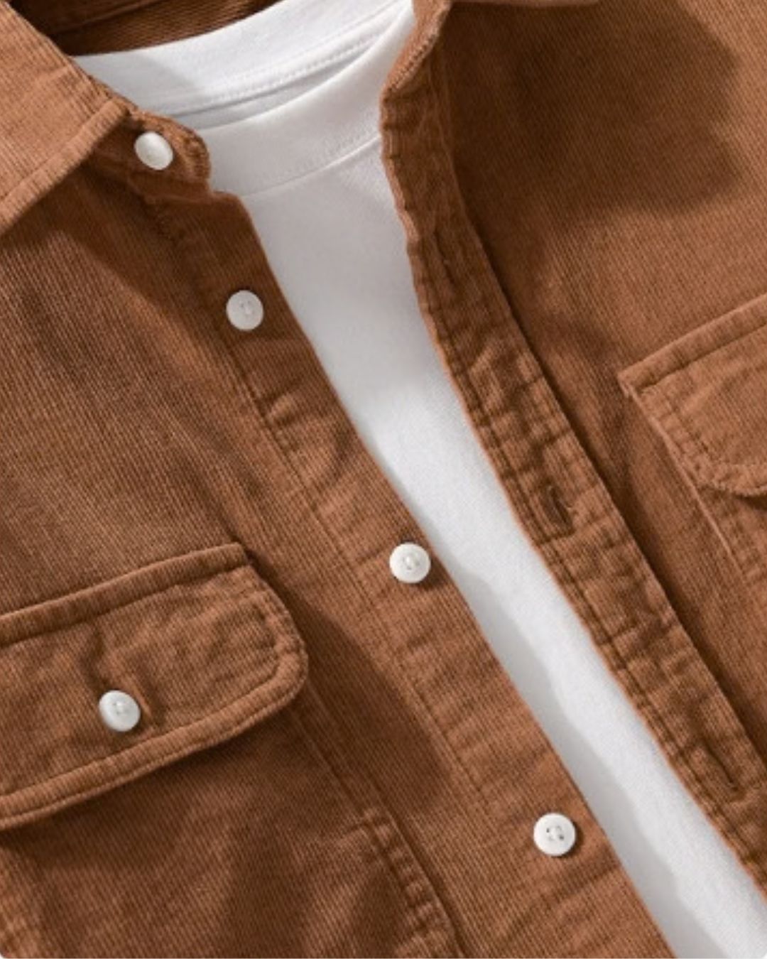 Brown cotton corduroy button-up shirt with chest pockets worn open over a white T-shirt.