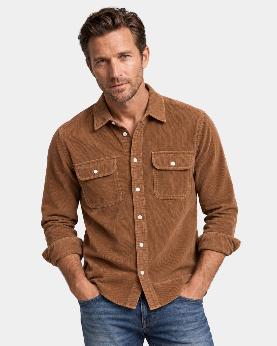 Man wearing a brown cotton corduroy button-up shirt with a turn-down collar, two chest pockets, and long sleeves.