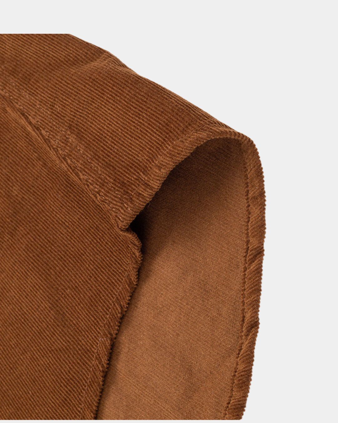 Close-up of a brown men’s cotton corduroy shirt showing the soft ribbed texture and fabric quality.