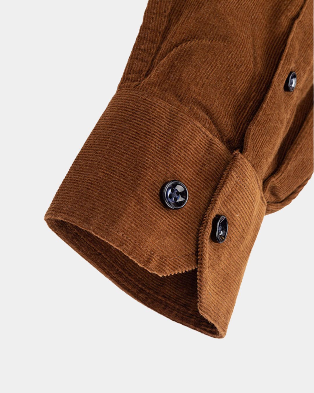 Close-up of a brown cotton corduroy shirt sleeve featuring a ribbed texture and dark buttoned cuffs.