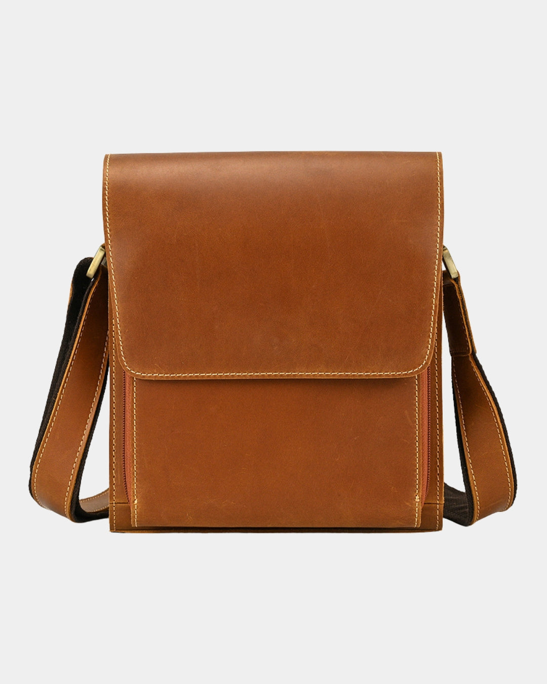 A brown leather crossbody bag with a front flap pocket and a matching adjustable shoulder strap.