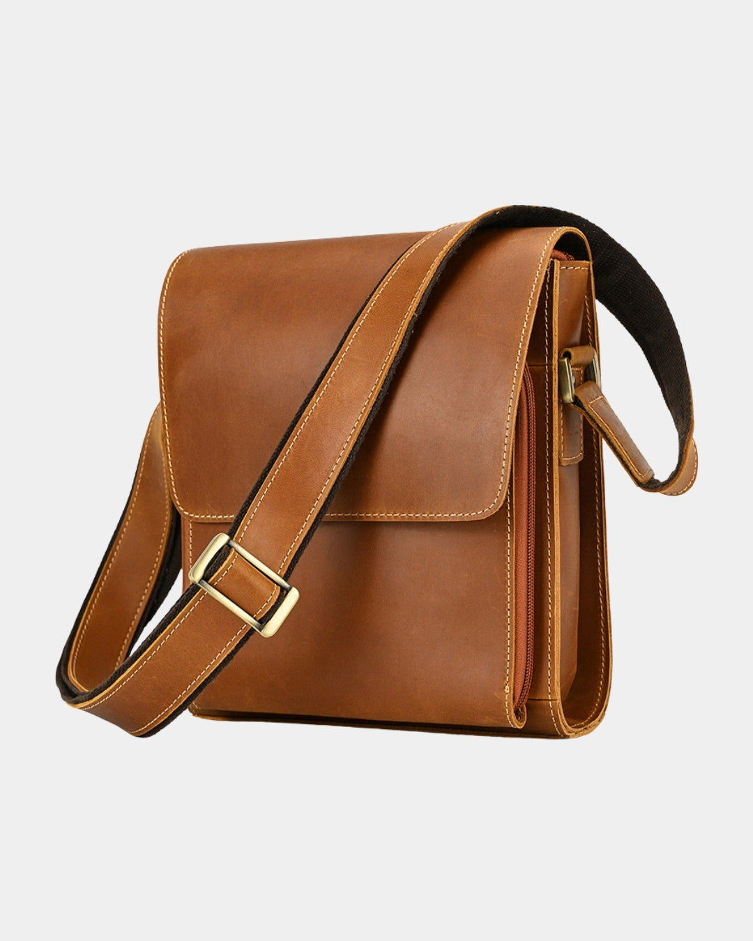 A brown leather crossbody bag with a wide adjustable strap, gold-tone buckle, and a side zipper.
