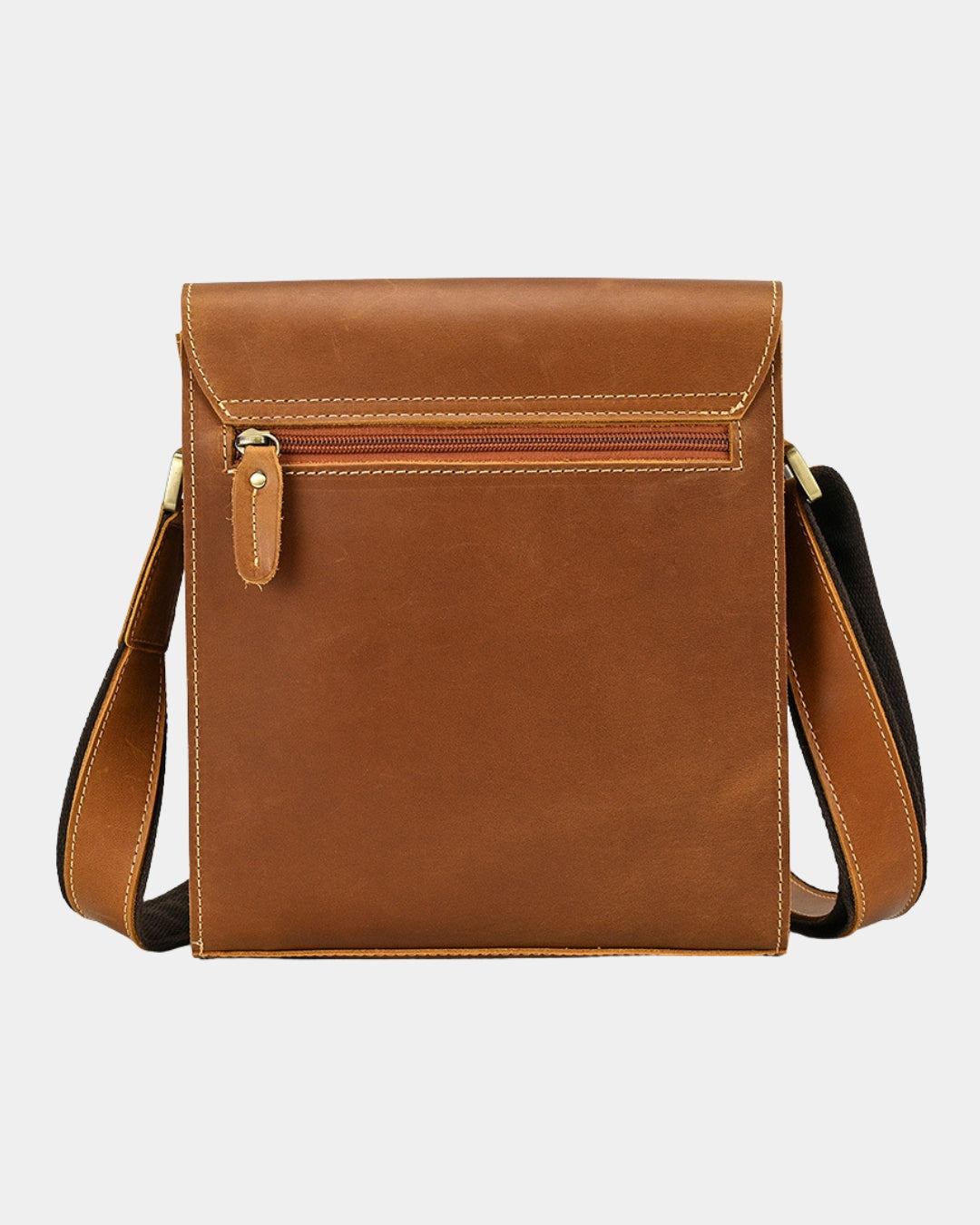 Back view of a brown leather crossbody bag with a zippered pocket and a matching adjustable shoulder strap.