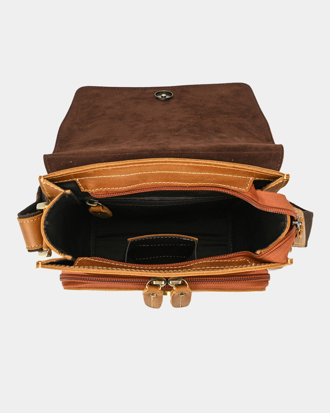 An open brown leather crossbody bag with a flap closure, showing a black interior, zippered compartments, and gold-tone hardware on a light gray background.