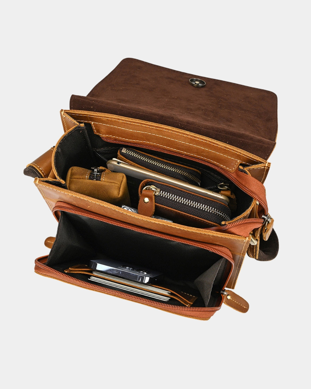 An open brown leather organizer bag showing its interior compartments, including zippered pockets, card slots, and a small pouch, photographed on a light gray background.