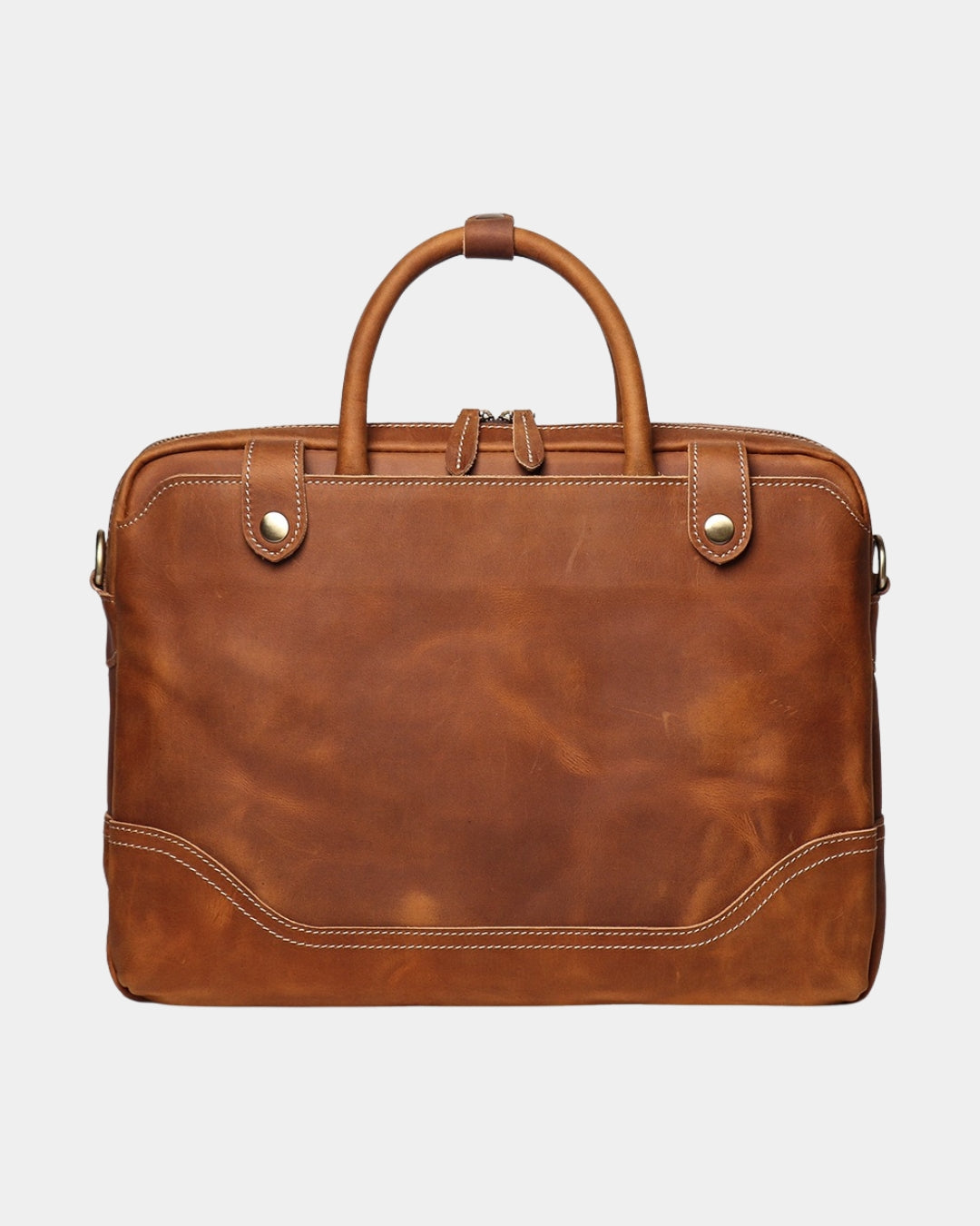 A cognac brown distressed leather briefcase with dual top handles, brass snap buttons, and contrast stitching, shown against a light gray background.