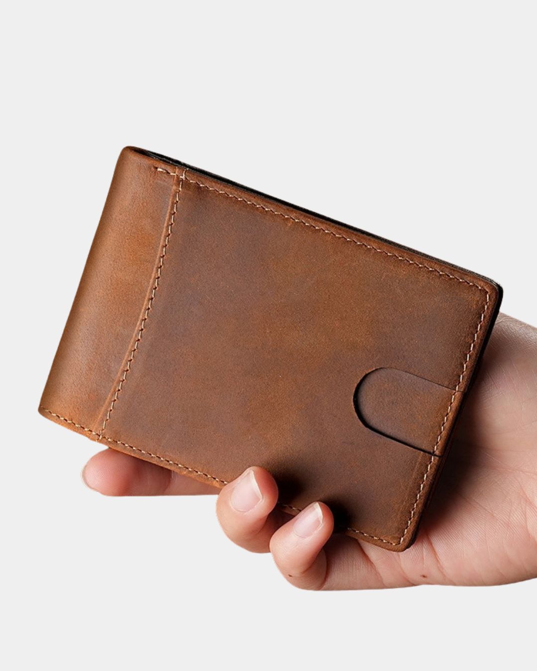 Brown Crazy Horse leather bifold wallet with an exterior quick-access card slot held in a hand.