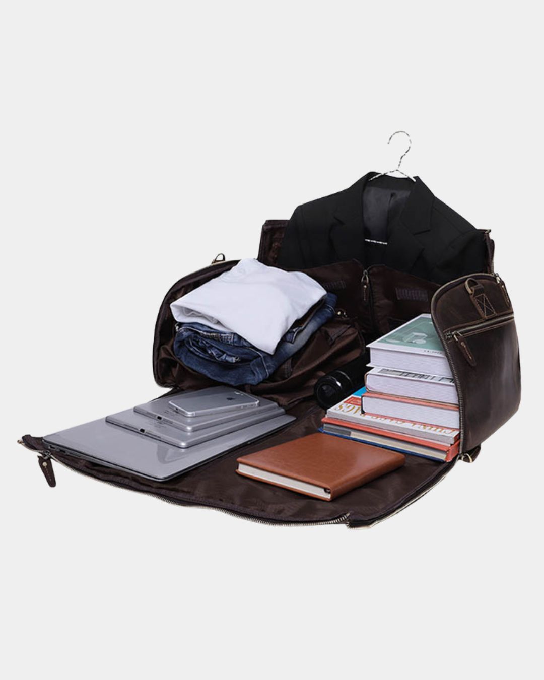 Brown Crazy Horse leather garment duffel bag opened flat, packed with a suit, clothing, books, and tech accessories.