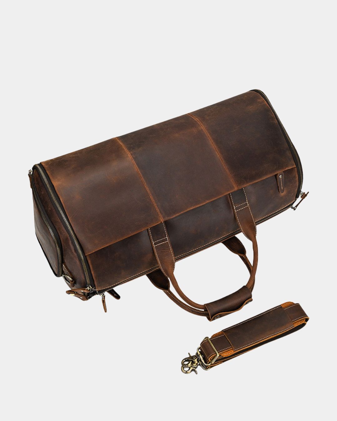 Brown Crazy Horse leather travel duffel bag with reinforced handles, side shoe compartment, and detachable shoulder strap.