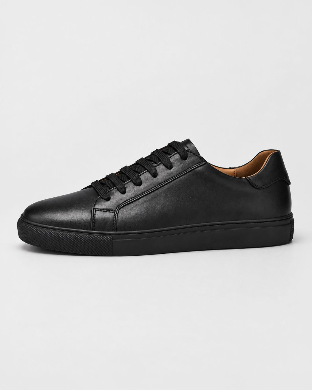 Men’s black low-top dress sneakers in genuine top-grain leather with a matching rubber outsole and lace-up closure.