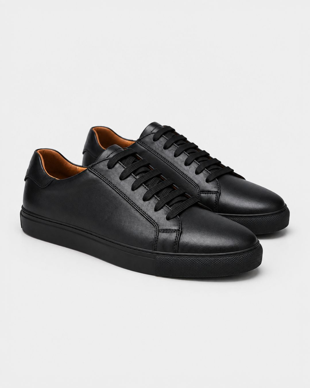 Men’s black genuine leather low-top dress sneakers with matching laces and a durable rubber outsole.