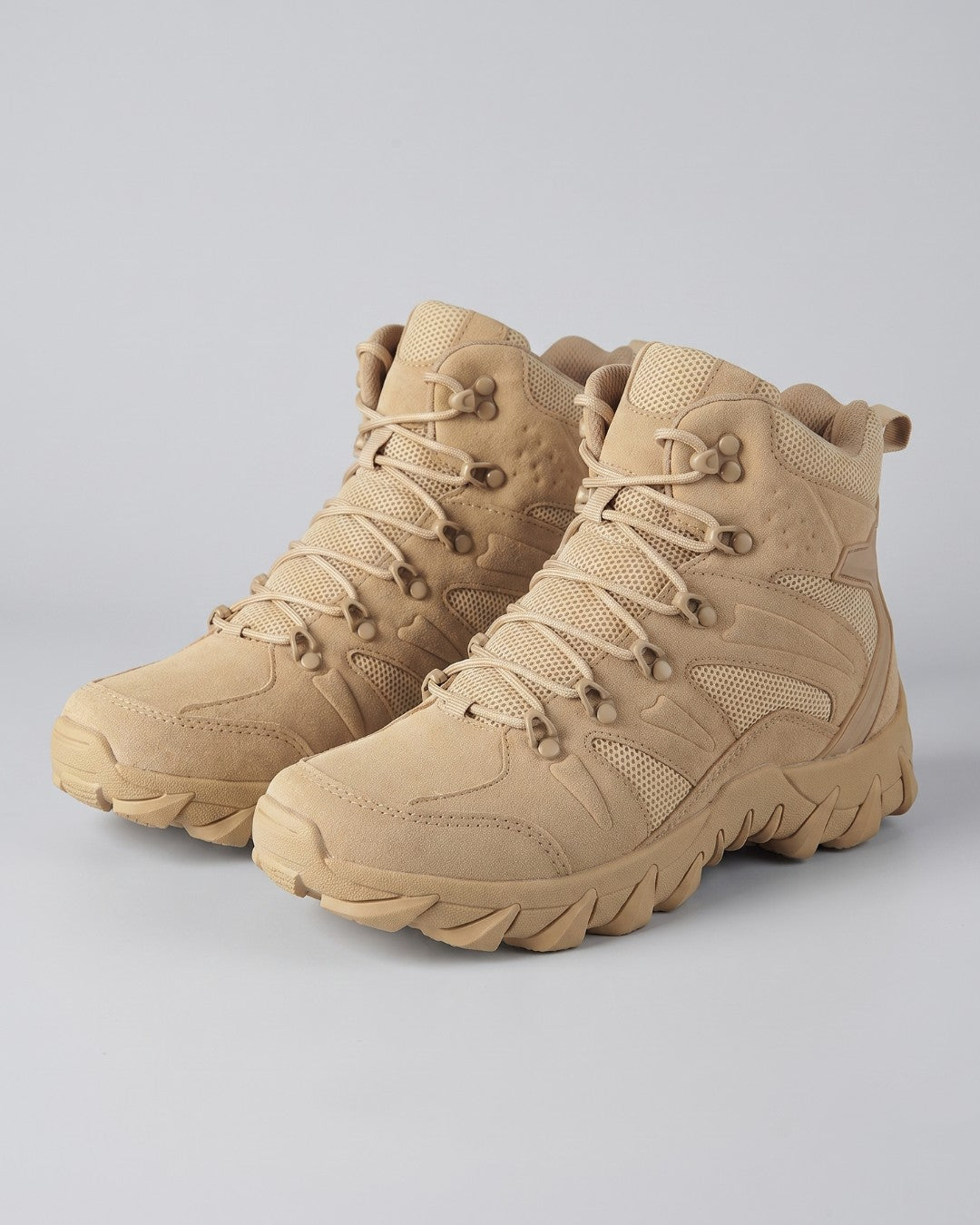 Mens hiking tactical combat boot in a beige color, shown from an angle by Hudson & Tate.