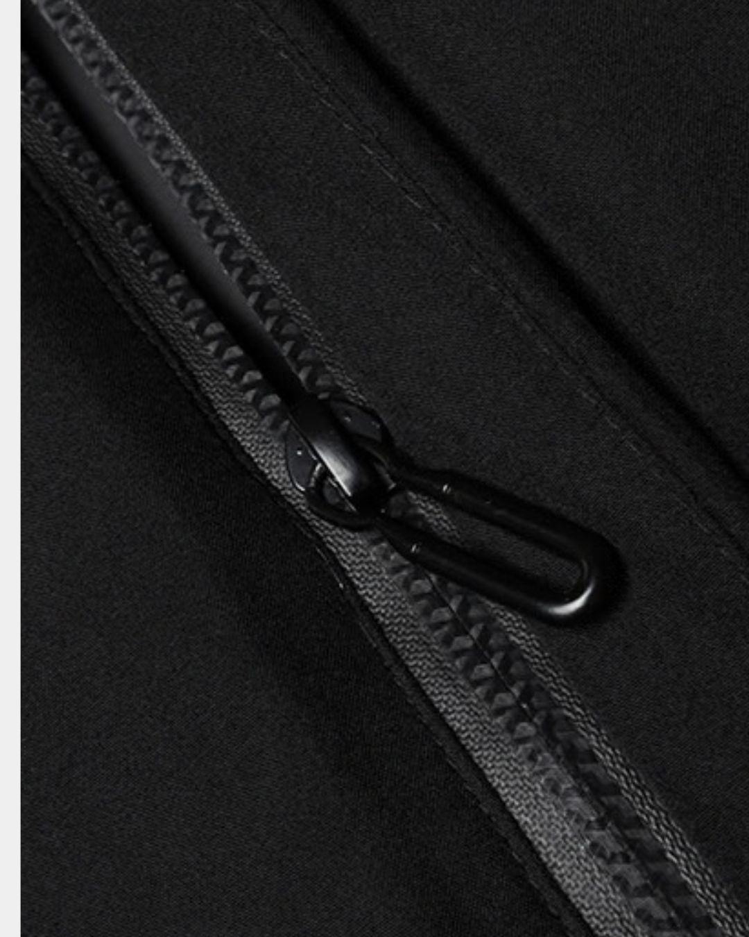 Close-up of a black men's winter parka featuring a durable, water-resistant full-length front zipper.